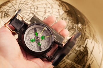 Magnetic old retro compass on the world map.