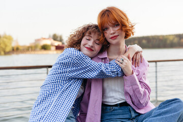 Two friends enjoying a sunny day by the lake 