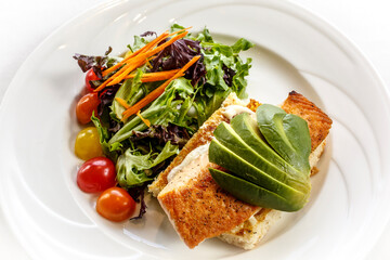 A plate of food with a salad and a sandwich