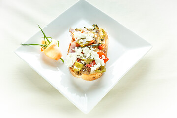 A plate of food with a cucumber and a piece of bread
