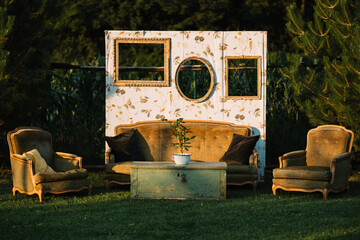 Vintage outdoor seating arrangement with green table.