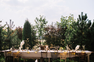 A long outdoor table ready for a rustic garden event