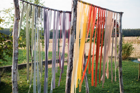 Varied color fabric strips on sticks outdoors in nature