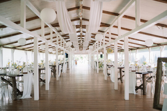 Elegant rustic venue with white decorations and tables