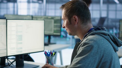 System administrator in server room doing system analysis, coding supercomputers. Specialist...