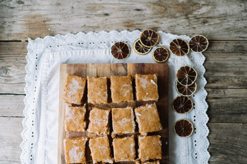 Neatly arranged brown glazed squares on wooden board.