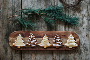Collection of tree-shaped decorated cookies on wooden board