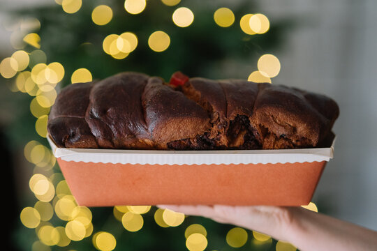 Loaf of enriched bread held with bokeh background sparkles