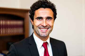 Portrait of a smiling lawyer posing in his office