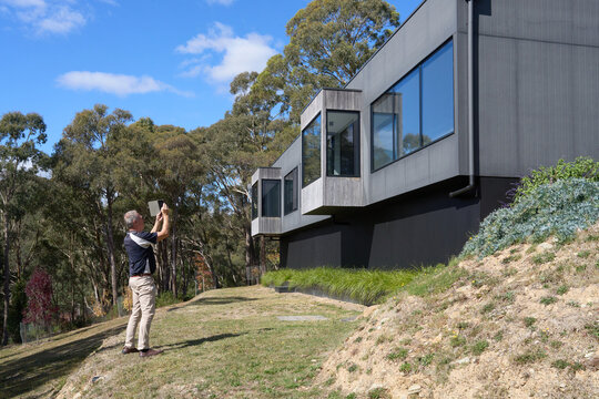 Building Inspector checking exterior of modern home