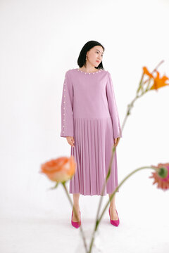 Woman in Pleaded Dress and Flowers