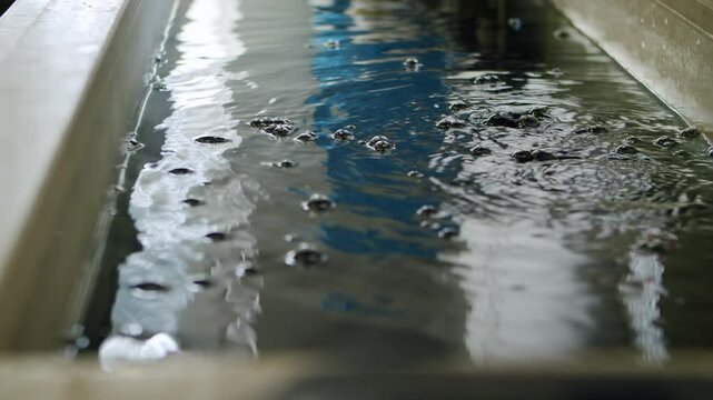 4K Industrial plating bath with rippling water surface, electroplating process for metal finishing, manufacturing technology, sustainable production, heavy industry practices
