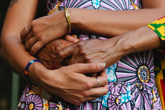 Close-up of mother and daughter holding hands