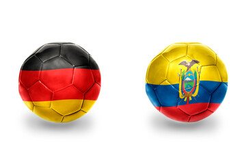 Obraz premium football balls with national flags of germany and ecuador ,soccer teams. on the white background.