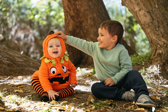 Delighted children joyfully dressed in Halloween costumes