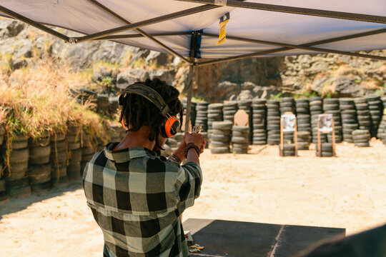 African man Shooting guns at gun range