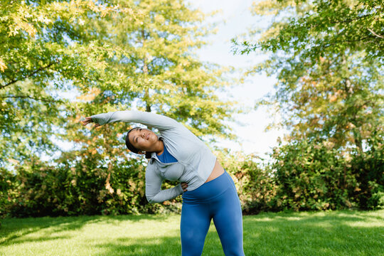 A woman does exercises in the park