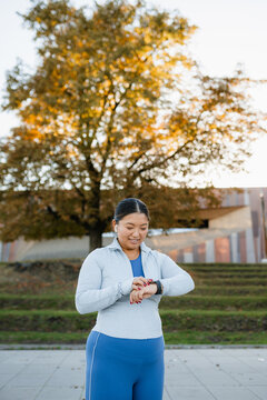 A woman uses an electronic watch