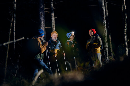 Friends talking during a night hike
