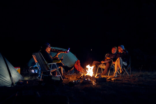 Group of people enjoys an overnight stay at a campsite