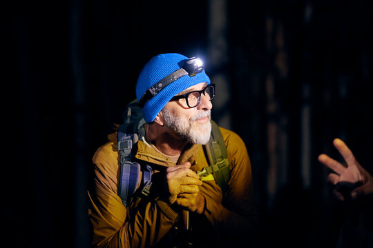 Portrait of a mountaineer wearing a headlamp