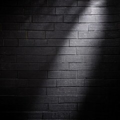 Sunlight or a lamp refracts and reflects onto a black wall with a texture that creates shadows dark background