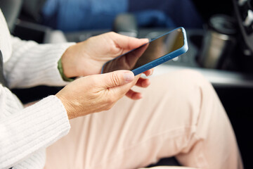 Anonymous woman holding smartphone