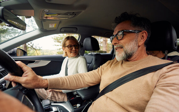 Friends enjoy their time traveling by car