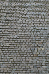 Background of cobblestone. Architecture background with stone cladding road. Concrete tiles background. Stone road background for poster or banner.