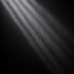 Sunlight or a lamp refracts and reflects onto a black wall with a texture that creates shadows dark background