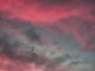 A moody, dramatic sky with dark clouds and a soft pink hue. Perfect for backgrounds or to evoke a sense of mystery and emotion