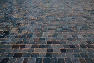 Fototapeta premium Pavement road. Stone cladding. Rough brick road. Cobblestone pavement background. Textured background. Sidewalk. Road. Old cobblestone road.