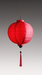 Obraz premium This stunning red lantern, adorned with a tassel, adds a touch of warmth and tradition to any space, symbolizing good fortune and joy in various cultures.
