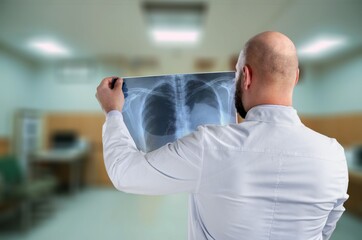 radiology doctor examining x ray film at hospital room.