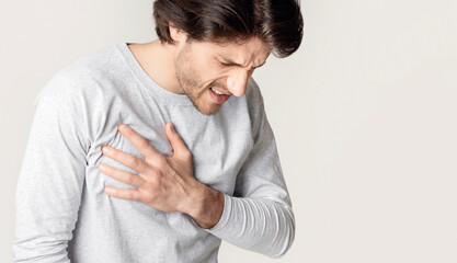Male heart disease. Man suffers from chest pain, free space