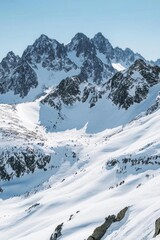 Snow-covered mountains under a clear blue sky, showcasing natural beauty.