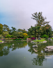 park in buenos aires, argentina, full of. green plants, threes and more with water all around