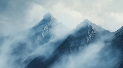 Obraz premium Misty mountains shrouded in clouds create a serene landscape.