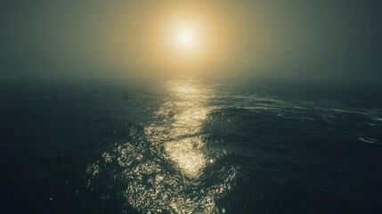 Sunlit ocean waves at sunset, hazy atmospheric perspective.