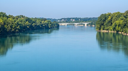 Fototapeta premium serene lake surrounded by lush green trees, reflecting a clear blue sky. New Covenant Land 