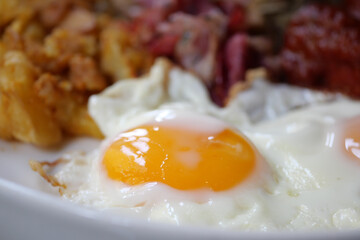 Enjoy a Delicious Breakfast Featuring Fried Eggs Accompanied by Tasty Sides