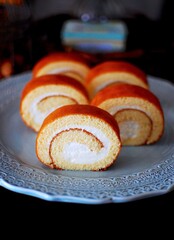 A soft, fluffy roll cake with a delicate sponge and creamy filling, perfect for a light dessert or afternoon snack. A sweet, indulgent treat with a smooth texture and rich flavor.
