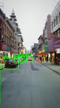 Autonomous car driving through a San Francisco Chinatown full of people. Computer vision with object detection system that creates boxes to recognize the different objects. Artificial intelligence.
