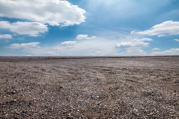 Desert sand ground under blue sky. Outdoor natural background.