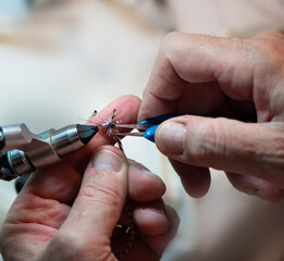 hands building a fly fishing fly