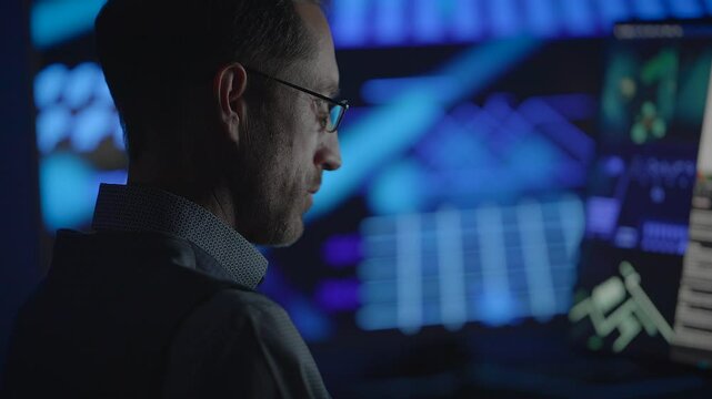 Dedicated and Focused Analyst Operates in a Sophisticated HighTech Control Room Setting