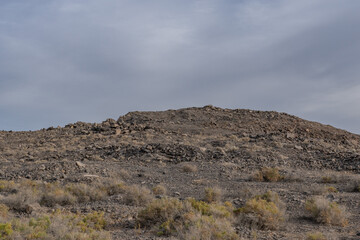 Obsidian Butte on the south shore of the Salton Sea. Calipatria, Imperial County, California. The Salton Buttes lie within the Salton Sea Geothermal Field. Rhyolite. dry lake bed.