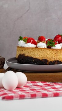 Vertical video Mexican chocoflan, impossible cake, flan napolitano, a mexican dessert with strawberries on top