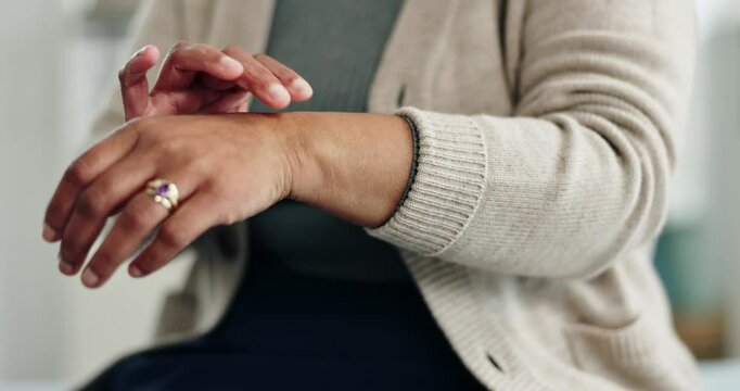 Old woman, hands and arthritis for wrist pain in home, massage joint and inflammation or disease. Senior person, sprain and swollen muscle by chronic fibromyalgia, hurt and osteoporosis or rheumatism