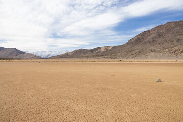 Moving rocks in the dry lake bed at The Racetrack at Death Valley National Park, California